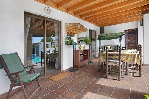 a room with a table and chairs on a patio at Casa Albryna Lanzarote in Tahiche