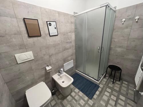 a bathroom with a shower and a toilet and a sink at Hostel Turin Metro Young in Turin