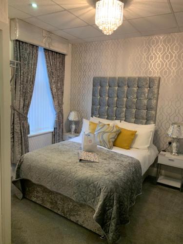 a bedroom with a bed with a laptop on it at Sorrento House in Blackpool