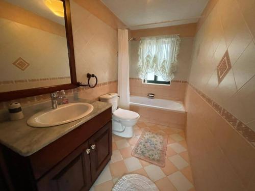 a bathroom with a sink and a toilet and a mirror at Harruba Flt 3 Triq il Gudja in Mġarr
