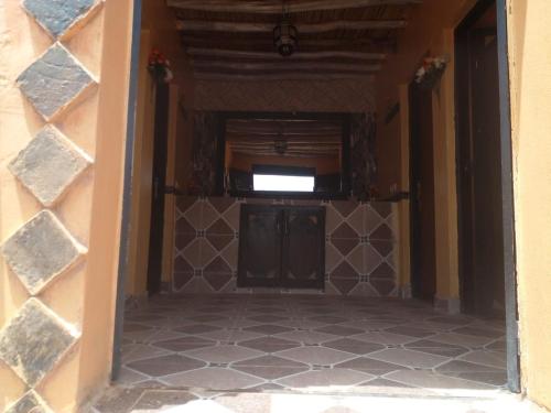 an empty hallway with a door and a tile floor at desert Feeling in Mhamid