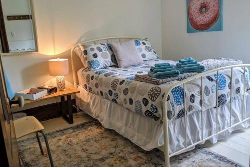 a bedroom with a bed and a table with a lamp at Bohemian Room in a 150-Year-Old Victorian House in Orangeville