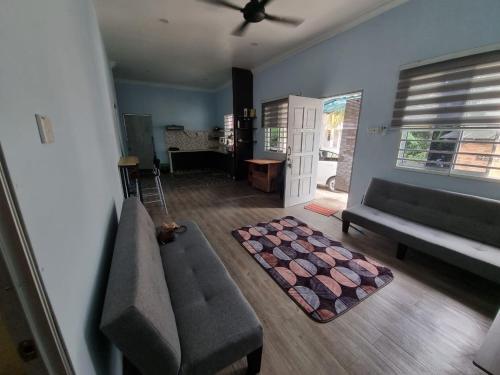 a living room with a couch and a table at IBAI COTTAGE KUALA TERENGGANU (HOMESTAY) in Kuala Terengganu