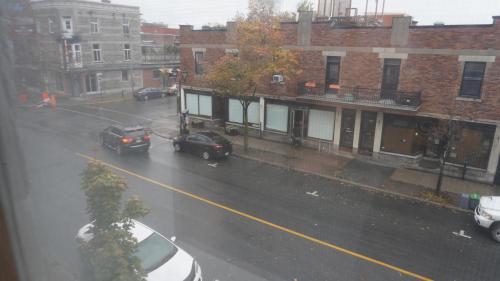 a view of a street with cars parked on the road at HoMa Homestay Hotel by Olympic Stadium Montreal Auberge-Hostel in Montréal