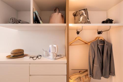 a room with a shelf with a coffee maker on it at Hotel Anfora Ibiza in Es Cana