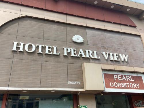 a hotel pearl view sign on the side of a building at Hotel Pearl View - Near US Embassy BKC in Mumbai