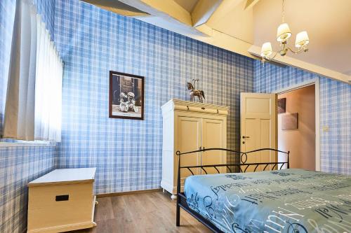 a bedroom with blue tiled walls and a bed at Wellness B&B De Zevenslaper in Geetbets