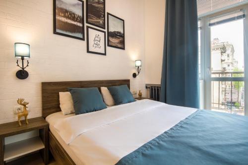 Кровать или кровати в номере Central Apartments Palats Sportu Area