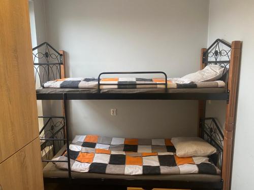 two sets of bunk beds in a room at Hostel pracowniczy ORBITA in Wólka Kosowska
