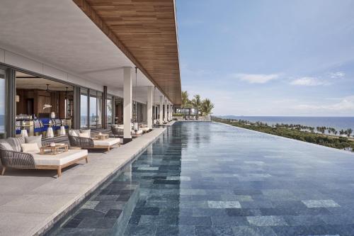 an infinity pool at a resort with a view of the ocean at Regent Phu Quoc in Phu Quoc