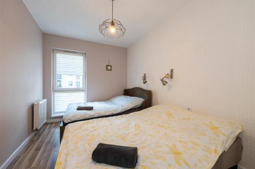 a bedroom with two beds and a window at Luxury in City -8- Free Parking in Łódź