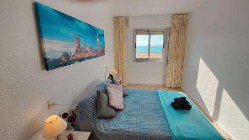 a bedroom with a bed and a view of the ocean at Sea view 3-bedroom flat in Puerto de Mazarron in Puerto de Mazarrón