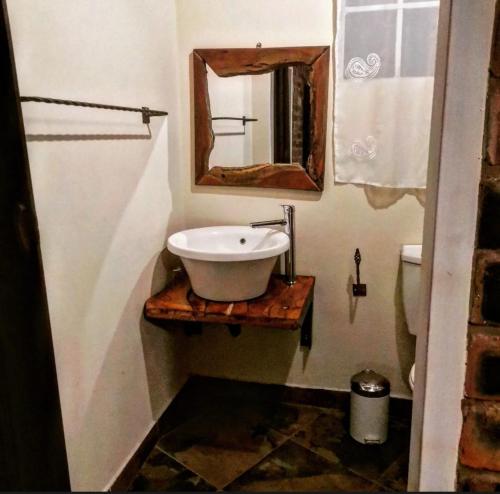 a bathroom with a sink and a mirror at Monkey Mountain Family Lodge in Gemsbokfontein