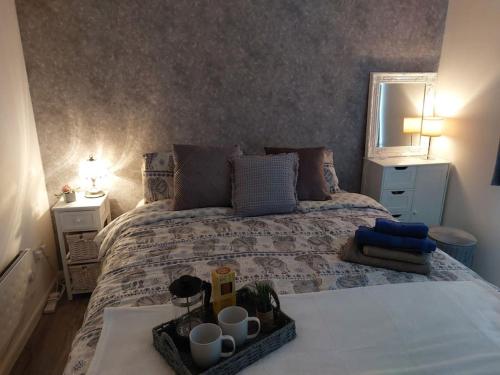a bedroom with a bed with a tray on it at Comfortable 2 bedroom house in historic Exeter in Exeter