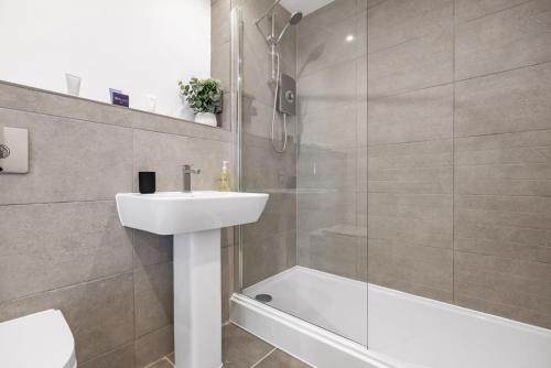 劍橋的住宿－Tailored Stays - Water Street Apartments，一间带水槽、淋浴和卫生间的浴室