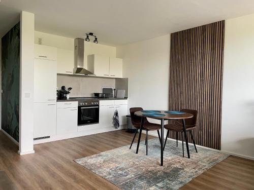 a kitchen and dining room with a table and chairs at River Main I Taunus View I Workplace I Kitchen in Offenbach