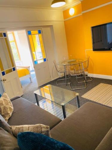 a living room with a couch and a table at Goldcroft in Abertillery