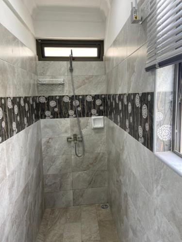 a bathroom with a shower with a shower at L'Heritage - Vue sur mer in Rodrigues Island