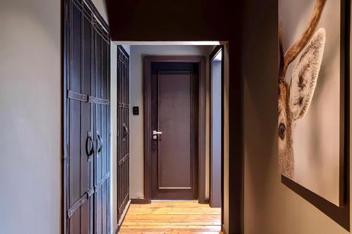 a hallway with a door and a wooden floor at Ort Hotel in Campos do Jordão
