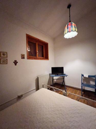 a room with a bed and a laptop on a table at Porta degli Elfi-Residence San Vito in Pescocostanzo