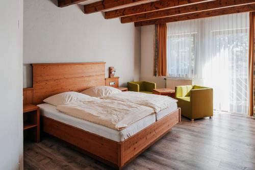 1 dormitorio con 1 cama grande y 2 sillas en Hotel Birkenhof, en Heidelberg