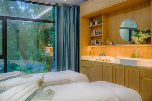 a hospital room with two beds and a window at L'Orangerie du Château des Reynats in Chancelade