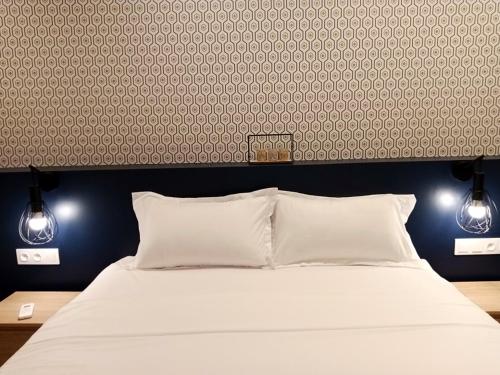 Ένα ή περισσότερα κρεβάτια σε δωμάτιο στο Waypoint Suites