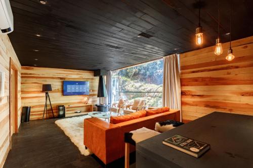a living room with a couch and a table at Ort Hotel in Campos do Jordão
