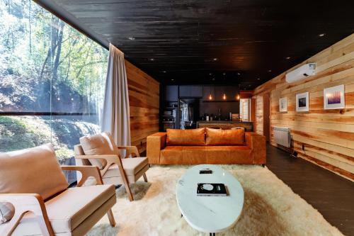 a living room with a couch and a table at Ort Hotel in Campos do Jordão