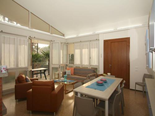 a living room with a couch and a table at Ville Alba e Alessandra in Lignano Sabbiadoro