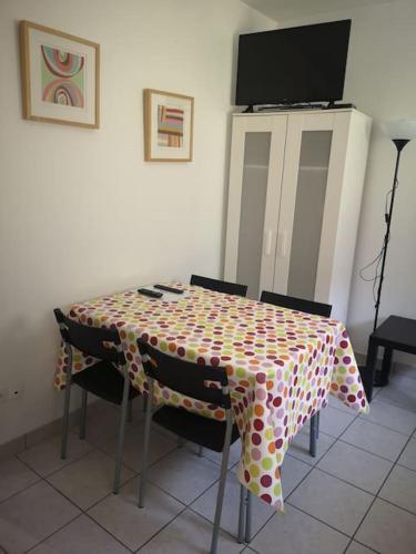 a table with chairs and a table cloth on it at Studio Chaleureux in Albert