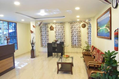 a living room with a couch and a piano at Aashrey Bed and Breakfast in Port Blair