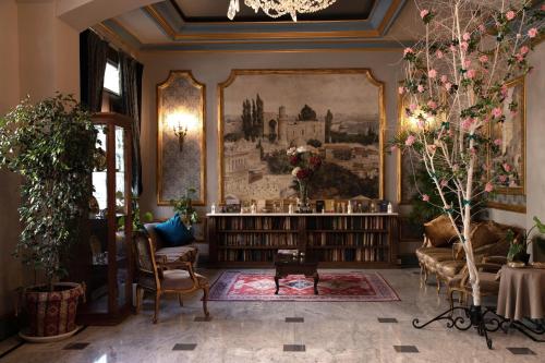 a library with a large painting on the wall at Sapphire City Hotel in Baku