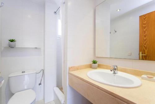 a bathroom with a sink and a toilet and a mirror at Isabela 2a 3 habitaciones con ático in Port de Pollensa