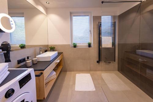 a bathroom with a sink and a shower at FESH LIVING in Kaprun