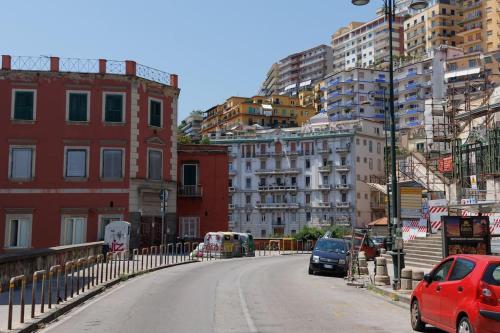 una strada in una città con edifici e automobili di Chiaia Stunning SeaView StudioFlat with 2 Terraces By HouseinNaples a Napoli