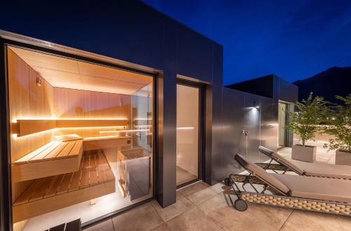 a house with a desk and a chair on a patio at FESH LIVING in Kaprun