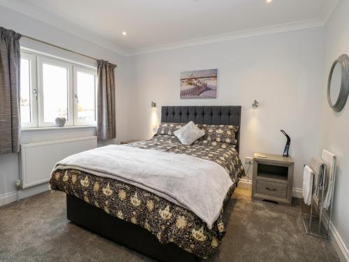 a bedroom with a large bed and a window at Robin's Nest in Brisley
