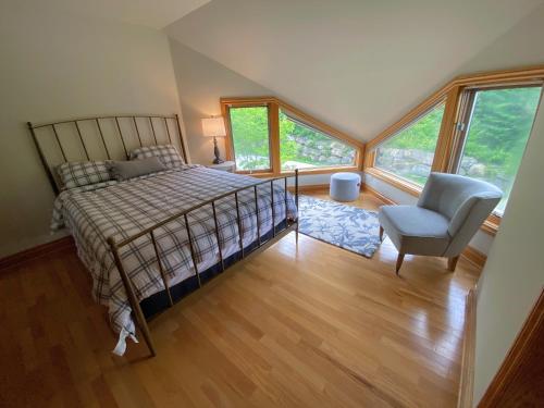 a bedroom with a bed and a chair and a window at CR1 Top Rated Ski-In Ski-Out Townhome Great views fireplaces fast wifi AC - Short walk to slopes in Carroll