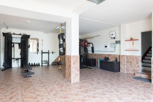 a room with a gym with a tile floor at LUXURY VILLA WITH PRIVATE POOL WITH AIRCON,Playa del Duque in Adeje