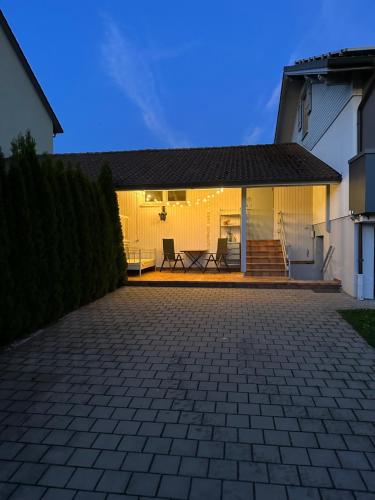 a house with a brick driveway in front of it at Appartement Maasai Mara mit Whirlpool und Sauna in Bad Saulgau