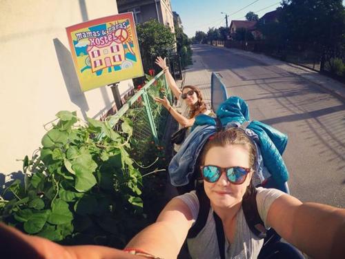 two women are standing on the side of a street at Hostel Mamas & Papas in Gdańsk