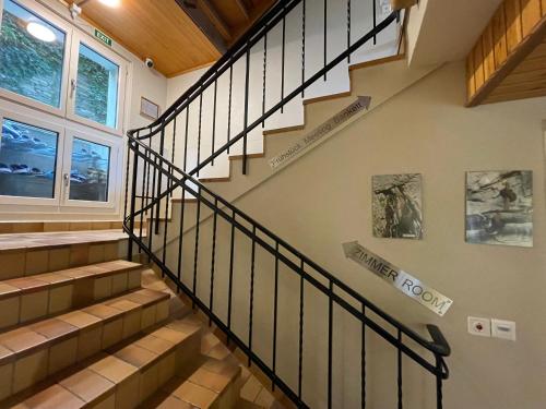 a winding staircase in a house with a window at VISPERBLICK 24-7 Parkplatz und Frühstück inkl in Ausserberg