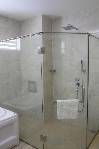 a shower with a glass door in a bathroom at West Hotel in Can Tho