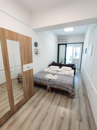 a bedroom with two beds and a mirror at Sole Mio Apartment & Wellness in Herceg-Novi
