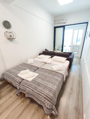 a bedroom with two beds and a large window at Sole Mio Apartment & Wellness in Herceg-Novi