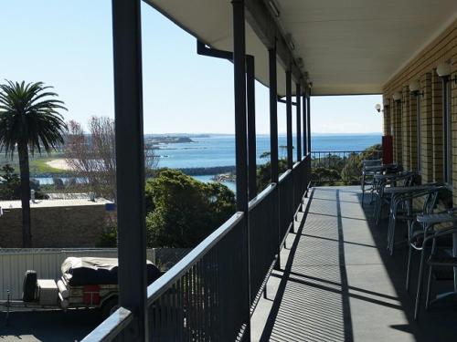a person laying on a porch of a house at Coastal Comfort Motel in Narooma