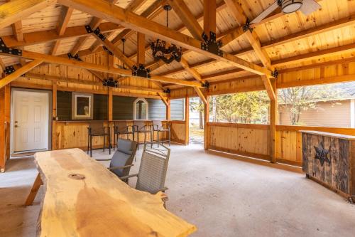 a large wooden pavilion with a table and chairs at The Magnificent 7 in Columbia Falls