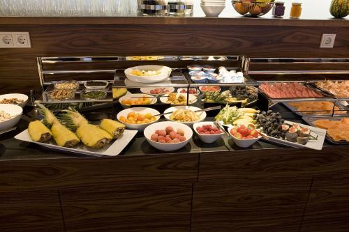 a buffet line with many different types of food at Pepis Skihotel in Sankt Anton am Arlberg