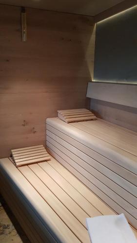 a sauna with two wooden beds in it at Alpenchalet Vils Tirol in Vils